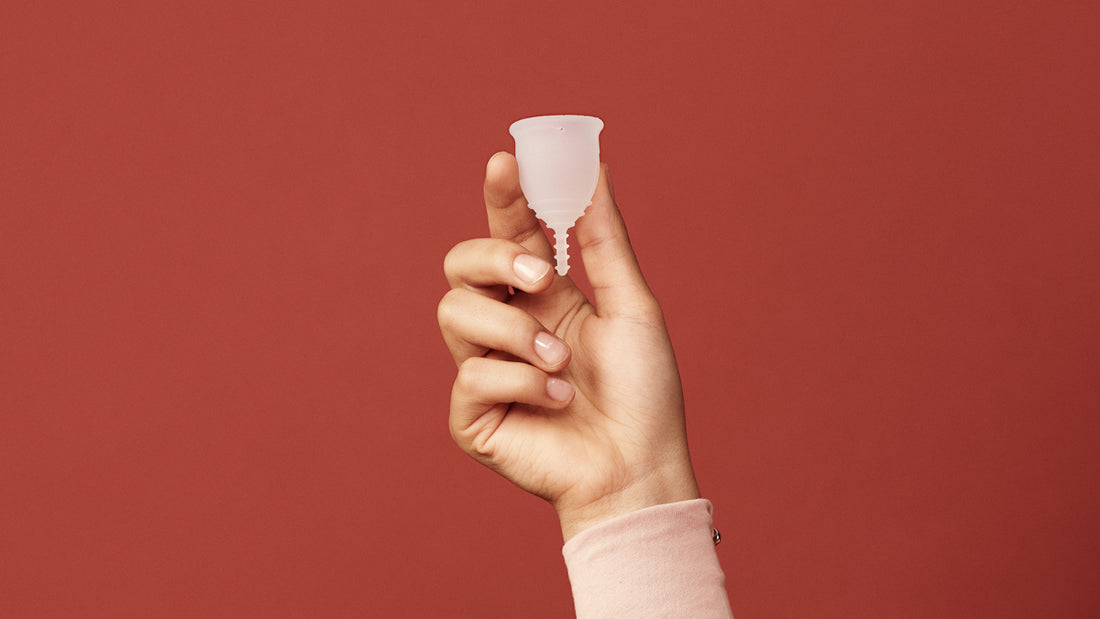 Hand holding a menstrual cup